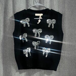 Black Sleeveless Top/Vest with Silver Bow Accents. Perfect for any holiday.  🖤